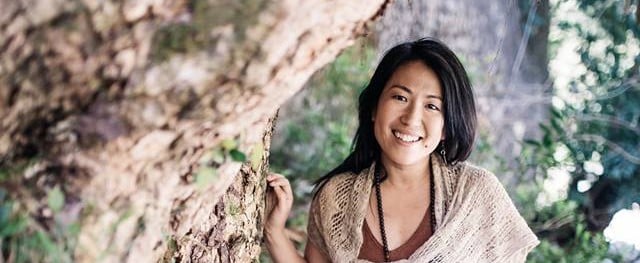 Kayo standing by a tree